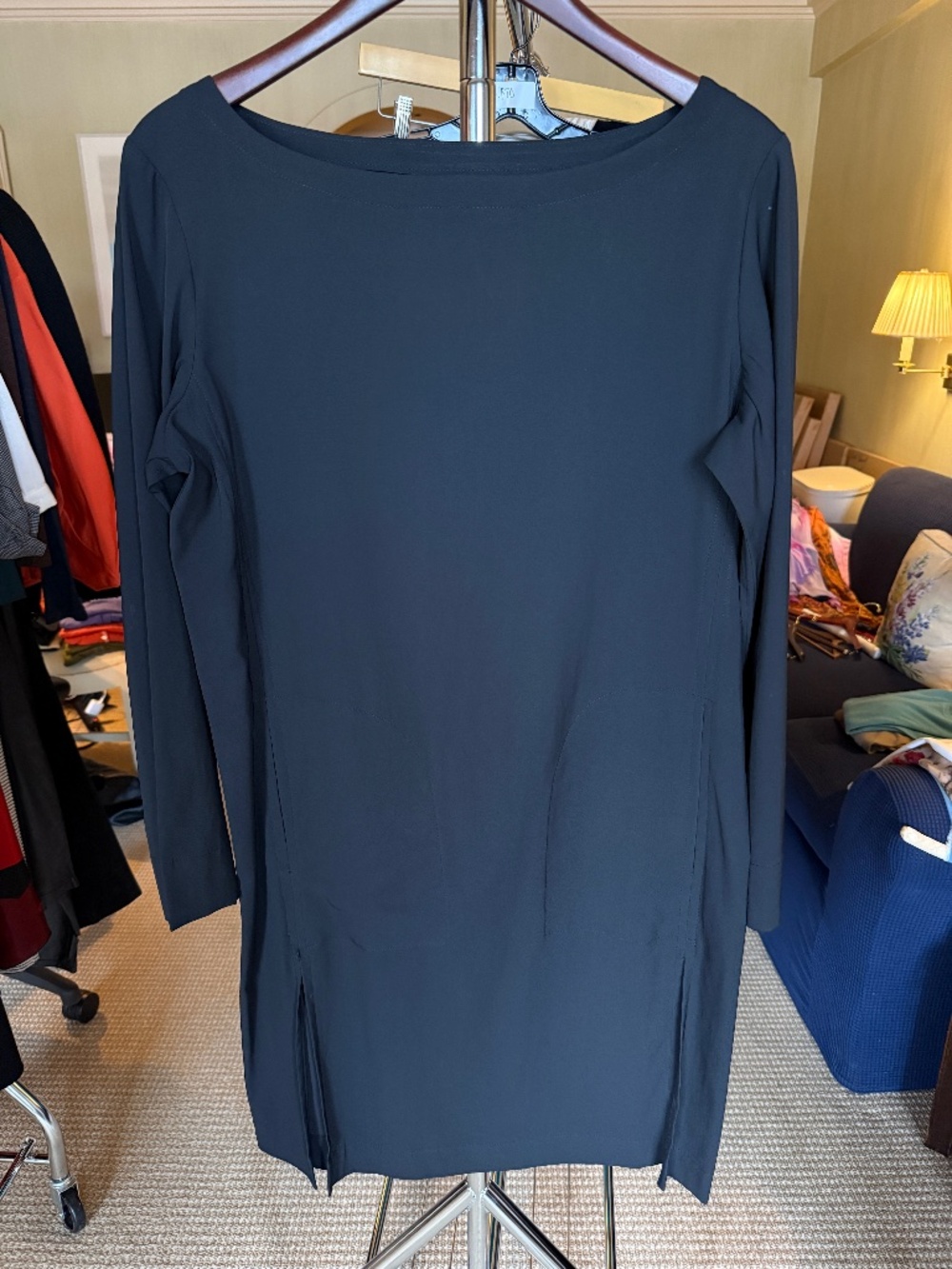 Minimalist black long sleeve shift dress with a sleek bateau neckline